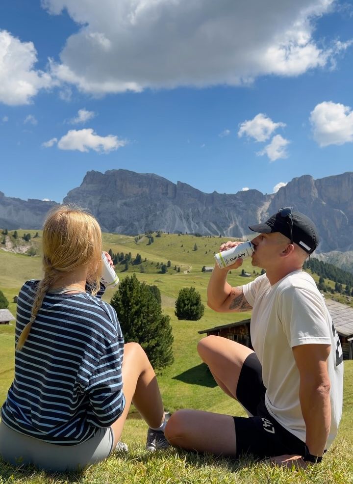 Resting with Purekey cans on a meadow below the Dolomites
